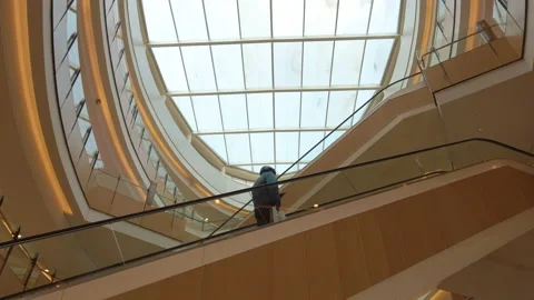 Delivery man taking escalator in shopping mall in COVID pandemic,Beijing,China Stock Footage 172458344