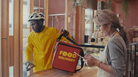Delivery Man Taking Food Order and Leaving Restaurant Stock Footage 252062863