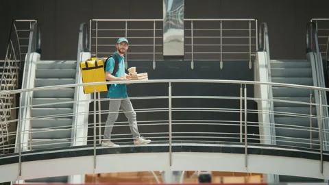 Delivery Man in Uniform With Thermal Backpack Brings Pizza Boxes, Coffee Video stock 211874902