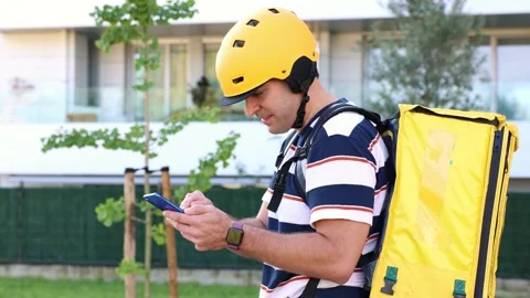 Delivery man using a smartphone for navigation Stock Footage 318096145