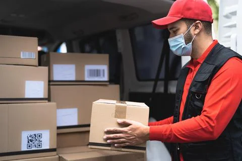 Delivery man wearing face protective mask to avoid corona virus spread Stock Photos