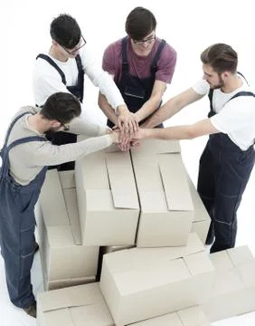 Delivery men carrying stack of boxes. Isolated on white Stock Photos