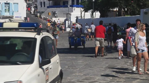 Delivery Motorcycle drives down a cobblestone street in Mykonos Stock Footage 39252801