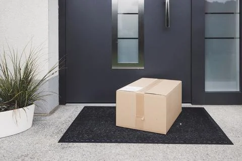 Delivery package left out at the front door - Surprise Christmas present Stock Photos