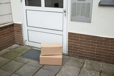 Delivery Of Parcel Boxes At Doorstep 库存照片