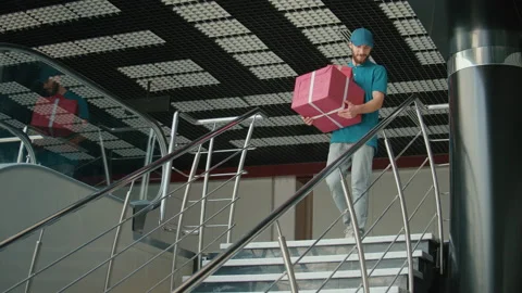 Delivery Person in Uniform, With a Thermal Backpack Brings Cardboard Box Package Stock Footage 211875824