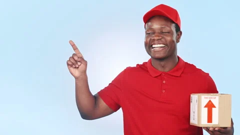 Delivery, pointing and face of black man with box, package and parcel on blue Stock Footage 251949123