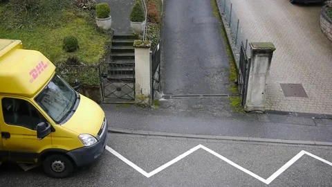 Delivery postman taking out a package from DHL Deutsche Post minivan Stock Footage 148554409