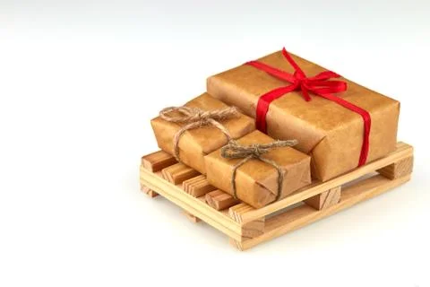 Delivery presents in three boxes with red ribbon on pallet for goods and logi Stock Photos