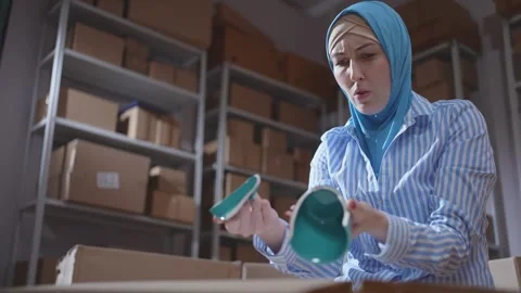 Delivery problems or logistics problem,box damage and a disgruntled hijab woman Stock Footage 284728227