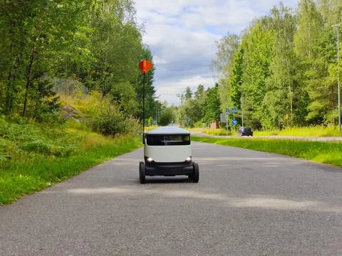 Delivery robot operating on a sidewalk in Espoo, Finland. Six-wheeled zero-em Stock Photos
