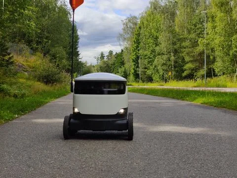Delivery robot operating on a sidewalk in Espoo, Finland. Six-wheeled zero-em Stock Photos