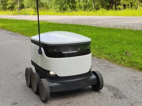 Delivery robot operating on a sidewalk in Espoo, Finland. Six-wheeled zero-em Stock Photos