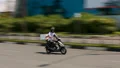 Delivery service employee rushing through city streets on moped with parcel HD Footage