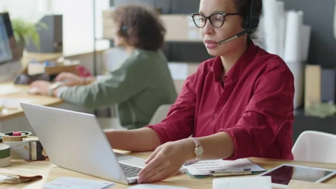 Delivery Service Specialist Talking via Web Call and Using Laptop Stock-Footage 228487500