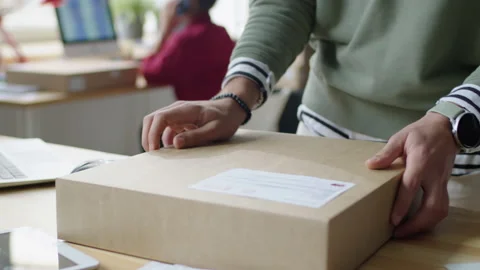 Delivery Service Worker Preparing Parcel for Shipping Stock Footage 228491780