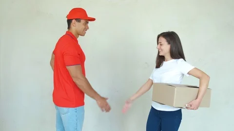 Delivery service worker in uniform delivering parcels to woman. Man holding 스톡 동영상 112759928
