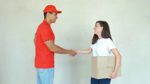 Delivery service worker in uniform delivering parcels to woman. Man holding 스톡 동영상 112759969