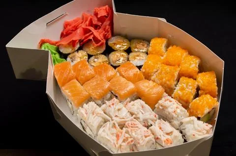Delivery of a set of rolls with red ginger and wasabi Stock Photos