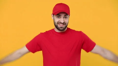Delivery strong fun young guy man in red cap blank t-shirt uniform workwear Stock Footage 136281654