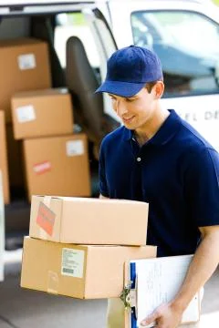 Delivery: taking boxes from van to home Stock Photos