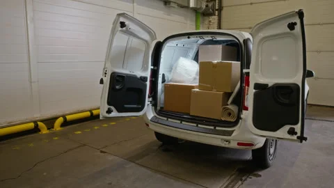 Delivery Van Loaded with Cardboard Boxes Inside Storage Unit Stock Footage 340282324