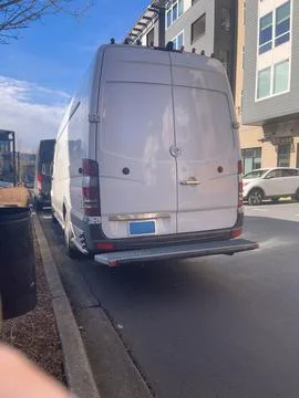 A delivery van in a residential complex Stock Photos