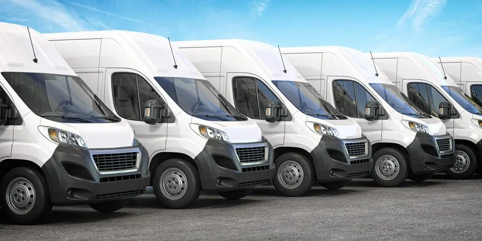 Delivery vans in a row.  Express delivery and shipment service concept. Stock Photos