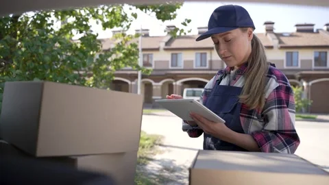 Delivery woman checking orders on tablet outdoors Stock-Footage 194787702