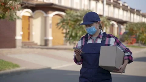 Delivery woman using mobile app on phone outdoors Stock-Footage 194787191