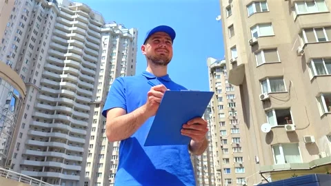 Delivery worker with clipboard stands confidently. Efficient delivery concept Vídeo Stock 336525783