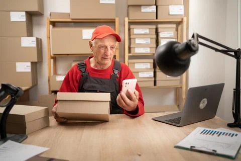 Delivery worker elderly man using laptop and mobile phone for logistics onl.. Stock Photos