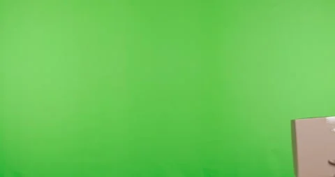 Delivery worker in red uniform offering parcel to camera 스톡 동영상 130352625