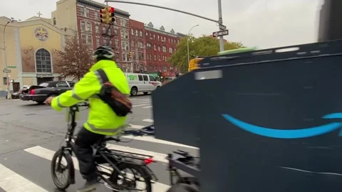 Delivery worker riding an Amazon Prime E-Assisted Vehicle in New York City Stock Footage 257123968