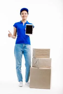 Delivery worker shows a tablet screen with info for three parcesls. Stock Photos