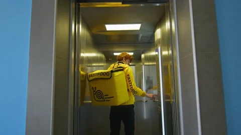 The deliveryman enters the elevator Stock Footage 236899462