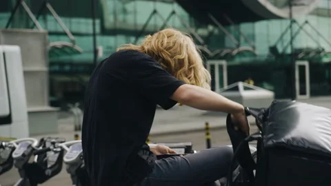 The deliveryman sat down on the bench to rest and took off the backpack Stock Footage 163892015