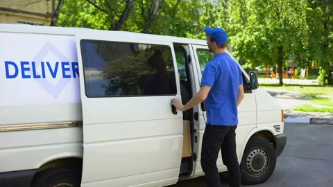 Deliveryman taking parcel box from van, courier service company, moving firm Stock Footage 91240038