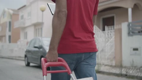Deliveryman wheeling cart with parcels Stock Footage 155376031