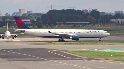 Delta air lines airbus a330 taxis along taxiway amsterdam schiphol airport Stock Footage 283666430
