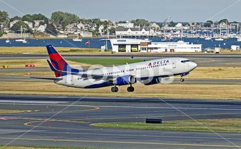 Delta Airlines Boeing 737 plane taking off runway Stock Photos