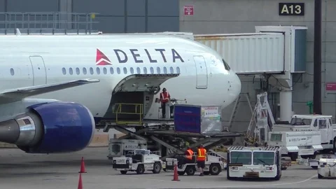 Delta Airlines loads cargo shipping containers, departure flight Stock Footage 69917005