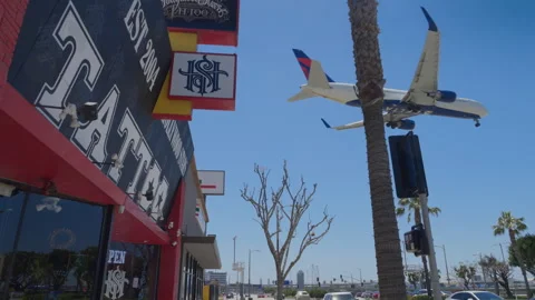 Delta Airlines plane flying over Sepulveda Blvd, approaching landing LAX airport Stock Footage 274623347