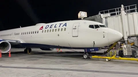 A Delta Airlines Plane Sits Empty At An Airport Stock Footage 145660198