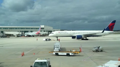 Delta airplane backing out of gate to the tarmac Video stock 247293897