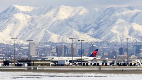 Delta commercial jet taxis at Salt Lake City International Airport in winter. Stock Footage