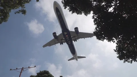 Delta plane flying low about to land in slow motion 120fps Stock Footage 89162375