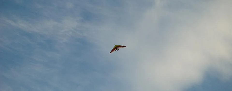 Delta wing with engine in open sky with yellow and red colors Stock Photos