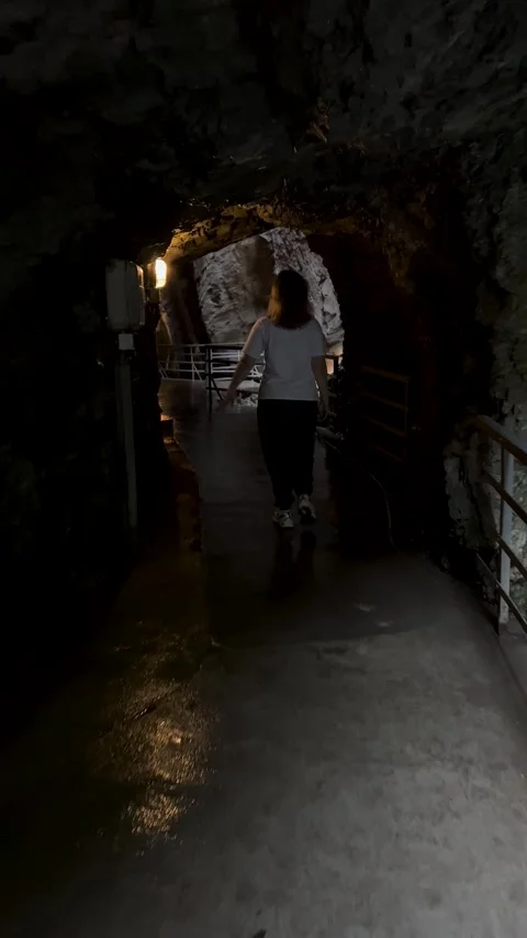 Delving into the Enigmatic Pathway of an Intriguing Cave Filled with Adventure Stock Footage 304784755
