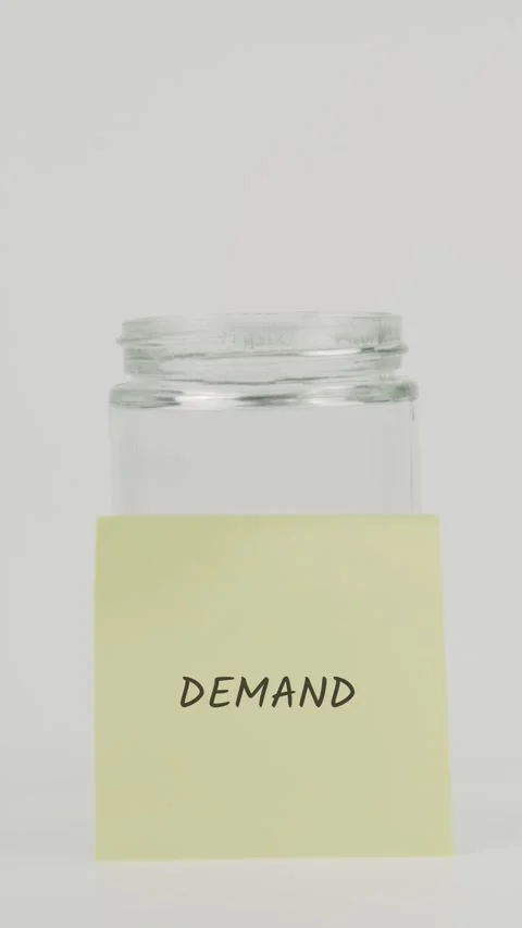 Demand text or word on yellow sticky note attached to glass jar with hand Stock Footage 311712737